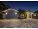 Gray house with yellow door, illuminated at night at 743 Chesapeake Dr, Tarpon Springs, FL 34689