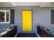 Yellow front door with black planters at 743 Chesapeake Dr, Tarpon Springs, FL 34689