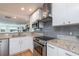 Sleek kitchen with stainless steel appliances and granite countertops at 743 Chesapeake Dr, Tarpon Springs, FL 34689