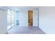 Bright bedroom with wood-look floors and sliding glass door to patio at 7499 7Th N St, St Petersburg, FL 33702