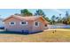Side view of the house showcasing the brick exterior and landscaping at 7499 7Th N St, St Petersburg, FL 33702