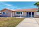 Front view of a remodeled brick ranch home with a red tile roof and carport at 7499 7Th N St, St Petersburg, FL 33702