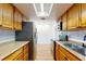 Kitchen with wood cabinets, stainless steel appliances, and granite counters at 7499 7Th N St, St Petersburg, FL 33702