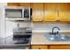 Stainless steel appliances and wood cabinets in this updated kitchen at 7499 7Th N St, St Petersburg, FL 33702