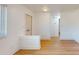 Bright living room with wood-look floors and white brick accent wall at 7499 7Th N St, St Petersburg, FL 33702