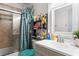 Bathroom with shower/tub combo and shelving at 7606 Woodbridge Blvd, Tampa, FL 33615
