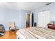 Bedroom with a double bed, chair, and ample closet space at 7606 Woodbridge Blvd, Tampa, FL 33615