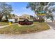 Community entrance sign for Morganwoods with landscaping at 7606 Woodbridge Blvd, Tampa, FL 33615