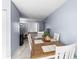 Open dining area with wooden table and chairs, overlooking living room at 7606 Woodbridge Blvd, Tampa, FL 33615