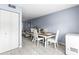 Dining area with white chairs and wooden table, open to living room at 7606 Woodbridge Blvd, Tampa, FL 33615