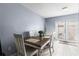 Dining area with wooden table and white chairs, near the back door at 7606 Woodbridge Blvd, Tampa, FL 33615