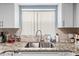 Kitchen with granite countertops and a double sink at 7606 Woodbridge Blvd, Tampa, FL 33615