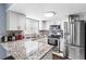 Updated kitchen featuring granite countertops and stainless steel appliances at 7606 Woodbridge Blvd, Tampa, FL 33615