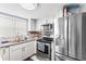 Modern kitchen with stainless steel appliances and granite countertops at 7606 Woodbridge Blvd, Tampa, FL 33615