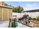 Small patio with grill, table, and potted plants at 7606 Woodbridge Blvd, Tampa, FL 33615