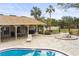 Community pool with patio area, tables, chairs, and lounge chairs at 7606 Woodbridge Blvd, Tampa, FL 33615