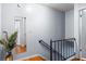 Indoor staircase with simple metal railing and wood flooring at 7606 Woodbridge Blvd, Tampa, FL 33615