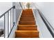 Indoor wooden staircase with black railings at 7606 Woodbridge Blvd, Tampa, FL 33615