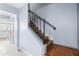 Indoor wooden staircase with black railing at 7606 Woodbridge Blvd, Tampa, FL 33615