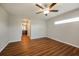 Bright bedroom with hardwood floors and ceiling fan at 7849 Grafton Rd, North Port, FL 34291