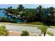 Aerial view of waterfront property with boat docks and lush tropical landscape at 8310 Marina Dr, Holmes Beach, FL 34217