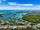 Aerial view of waterfront homes and lush landscaping at 8310 Marina Dr, Holmes Beach, FL 34217