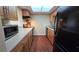 Kitchen with light wood cabinets and black appliances at 833 N Keene Rd # W12, Clearwater, FL 33755