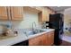 Modern kitchen with stainless steel sink and black refrigerator at 833 N Keene Rd # W12, Clearwater, FL 33755