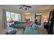 Living room with teal sectional and view of patio at 833 N Keene Rd # W12, Clearwater, FL 33755