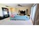 Living room with teal sectional sofa and mirror at 833 N Keene Rd # W12, Clearwater, FL 33755