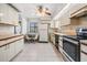 Kitchen with white cabinets, black appliances, and a breakfast nook at 867 Mandalay Ave, Clearwater Beach, FL 33767