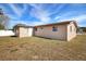 Home exterior view showcasing a large backyard at 9005 Hunt Club Ln, Port Richey, FL 34668