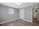 Bright bedroom featuring wood-look floors and ample closet space at 9005 Hunt Club Ln, Port Richey, FL 34668