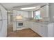 Newly remodeled kitchen featuring white cabinets, granite countertops, and modern appliances at 9005 Hunt Club Ln, Port Richey, FL 34668