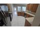 Well-lit kitchen with tile floors, wooden cabinets, stainless steel appliances, and light countertops at 9401 Azalea Ridge Cir, Tampa, FL 33647