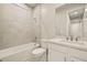 Modern bathroom with white vanity and grey tile shower at 11498 Boundless Ter, Venice, FL 34293