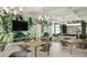 Community room with tables, chairs, and a large screen TV at 11498 Boundless Ter, Venice, FL 34293