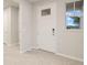 Bright entryway with tile floors and a white door at 11498 Boundless Ter, Venice, FL 34293