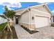 Single-story home with a two-car garage and landscaped walkway at 11498 Boundless Ter, Venice, FL 34293