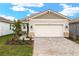 New construction home with a paved driveway and landscaping at 11498 Boundless Ter, Venice, FL 34293