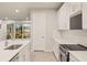 Modern kitchen with stainless steel appliances and white cabinets at 11498 Boundless Ter, Venice, FL 34293