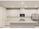 Modern kitchen featuring white cabinets and a large island at 11498 Boundless Ter, Venice, FL 34293