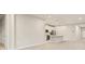 Open living area with a view of the kitchen and access to hallway at 11498 Boundless Ter, Venice, FL 34293