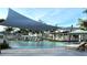 Resort-style pool with shade structures, lounge chairs, and a pool bar at 11498 Boundless Ter, Venice, FL 34293