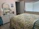 Bedroom with tropical bedding and white dresser at 12501 Ulmerton Rd # 64, Largo, FL 33774