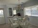 Bright dining area with glass table and white chairs at 12501 Ulmerton Rd # 64, Largo, FL 33774