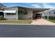 Mobile home with carport and landscaped yard at 12501 Ulmerton Rd # 64, Largo, FL 33774