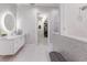 Elegant bathroom featuring stylish wallpaper, updated vanity and access to walk-in closet at 1902 4Th E St, Palmetto, FL 34221