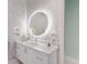 Bright bathroom with a large round mirror, modern vanity, and stylish decor at 1902 4Th E St, Palmetto, FL 34221