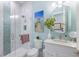 Bright bathroom featuring white cabinets, a glass shower, and blue accent wall at 1902 4Th E St, Palmetto, FL 34221